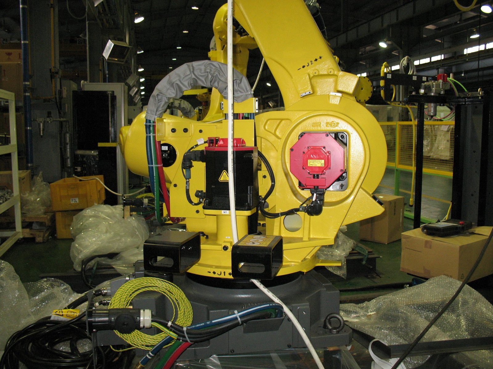 Braccio robotico industriale in cella automatizzata con periferiche