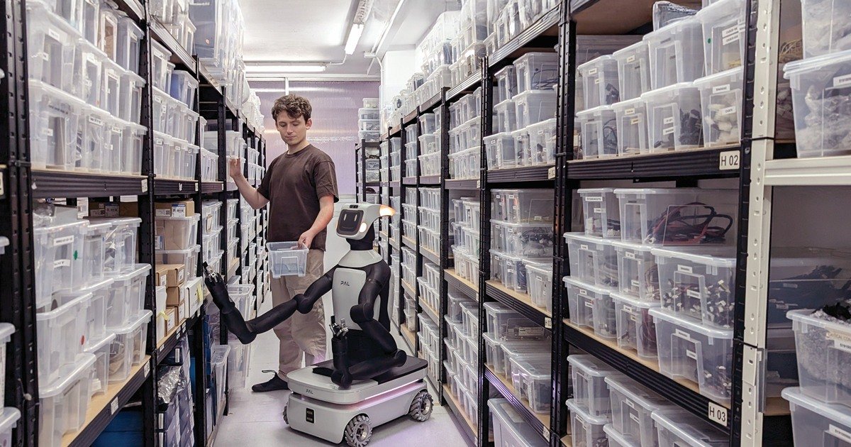 Robot mobile con bracci e operatore in magazzino automatizzato