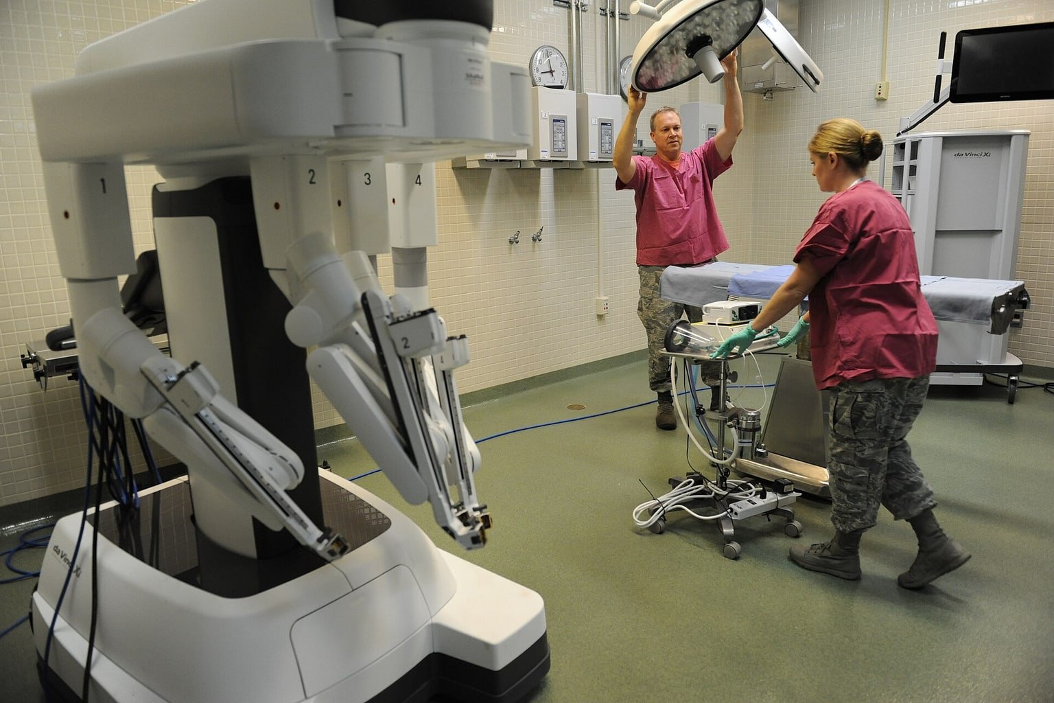 Team clinico in addestramento accanto a un sistema di chirurgia robotica