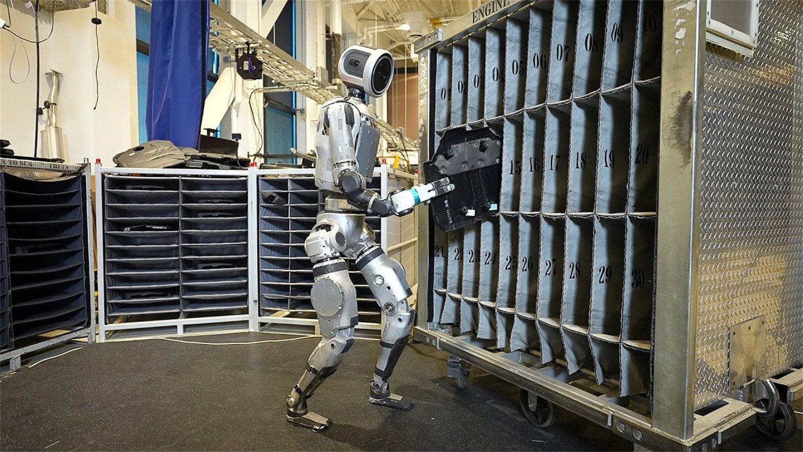 Atlas usa braccia e corpo per manipolare un carico pesante in laboratorio